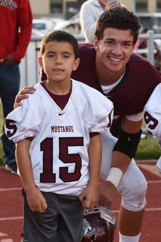 Tyler Chavez kneeling with his letter.