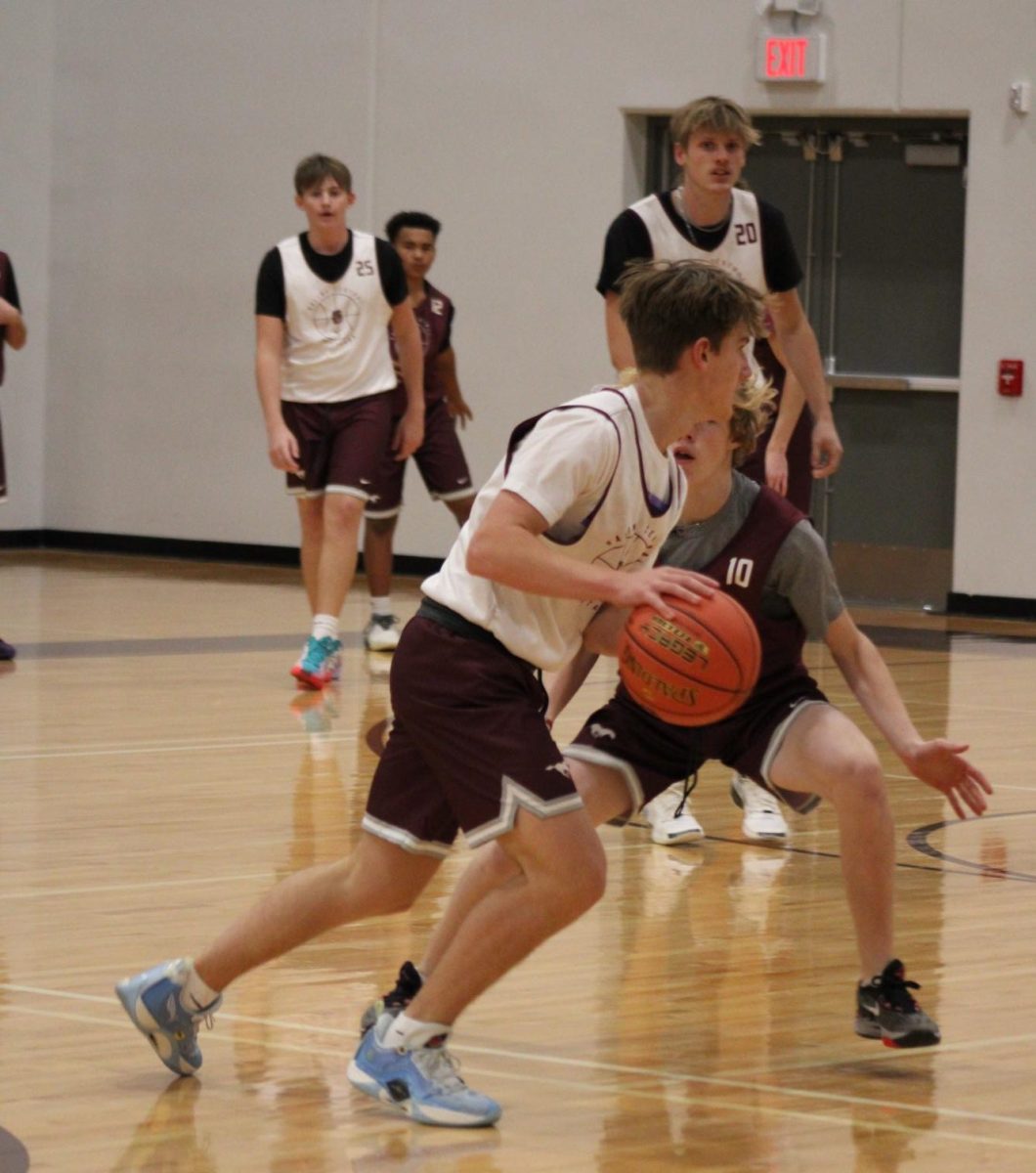 Junior Tommy Payne drives the ball against junior Gannon Cole