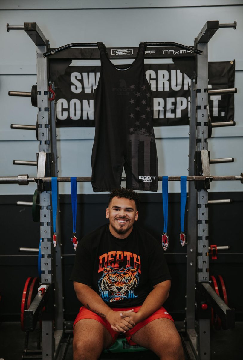 Peoples poses with his powerlifting medals